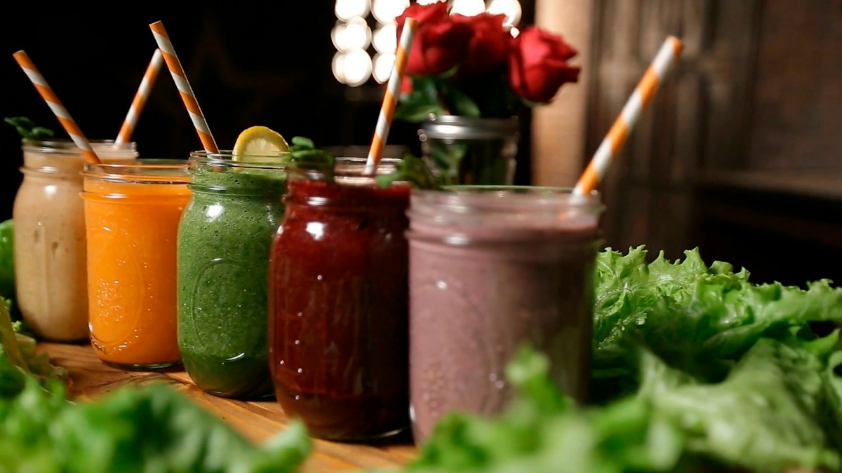 Colorful green smoothies in mason jars representing kale's immune-boosting micronutrients — vitamin C, sulforaphane, quercetin, and beta-carotene that build winter immune armor in October
